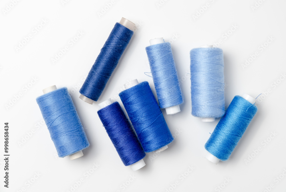 Blue thread spools on white background. Blue thread spools on white background.
