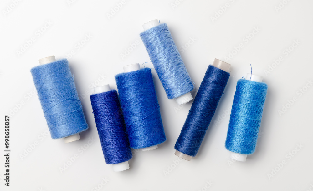 Blue thread spools on white background. Blue thread spools on white background.