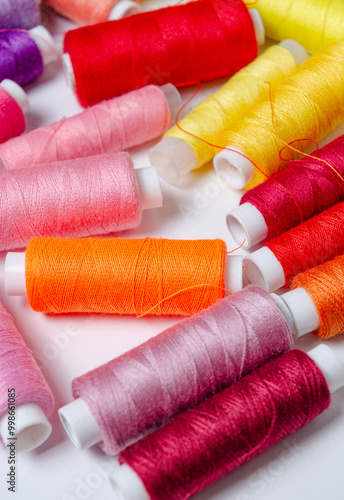 Top view of many colorful thread spools background