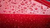 Hydrophobic water effect on red car paint after rain.