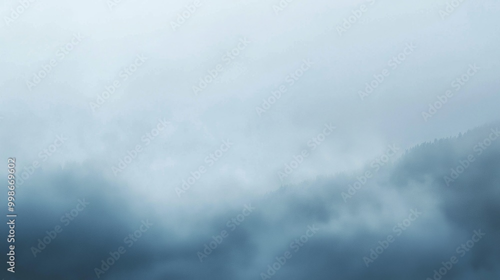 Dense fog is covering the mountain peaks on a cloudy day, creating a mysterious and atmospheric scene. The white and blue tones add to the serene and tranquil mood Dense fog is covering the mountain peaks on a cloudy day, creating a mysterious and atmospheric scene. The white and blue tones add to the serene and tranquil mood