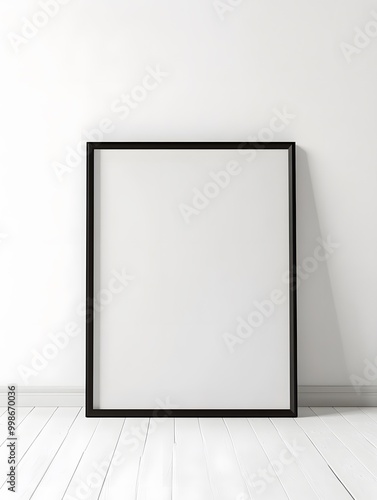 A minimalist black frame stands against a white wall, awaiting artwork, embodying simplicity and potential.