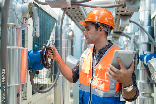 Engineers check and adjust the valves to ensure the proper amount of water flows into the air conditioning pipes.