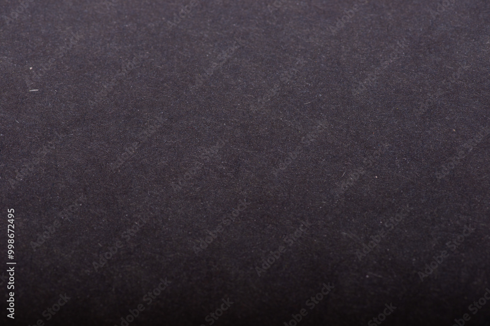 Close-up of natural craft paper texture, showcasing its earthy, raw, and eco-friendly material. Navy blue colour background.