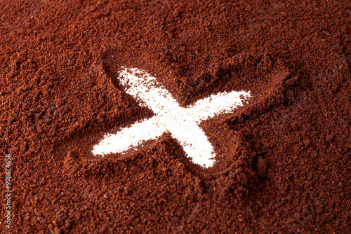 X symbol in coffee powder.