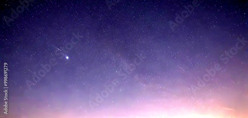 A bright comet streaks across the night sky, leaving a trail of light behind it, with a dark background and scattered stars