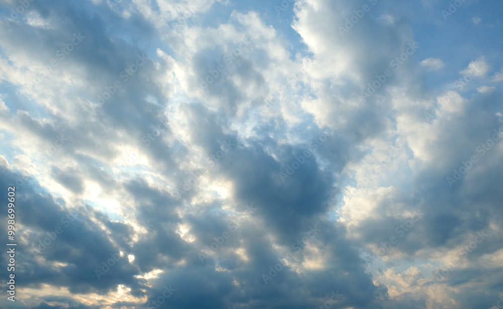 Fototapeta premium Dramatic cloudy sky with sunlight peeking through