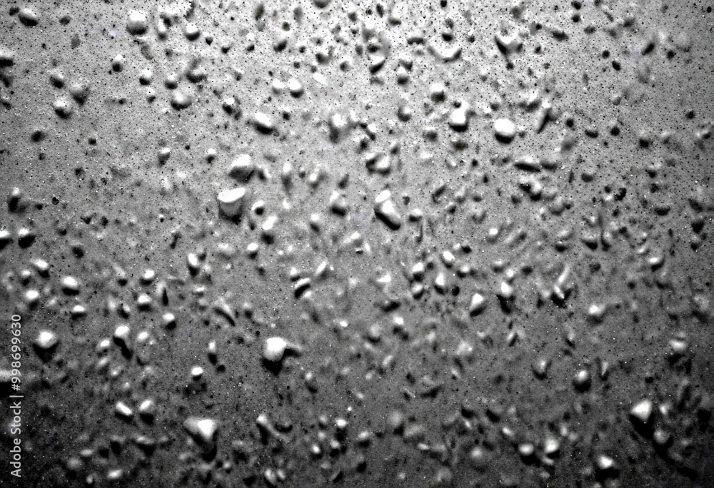 a close-up view dark, textured surface with numerous small, irregularly shaped droplets scattered across it, creating a sense of depth and complexity a close-up view dark, textured surface with numerous small, irregularly shaped droplets scattered across it, creating a sense of depth and complexity