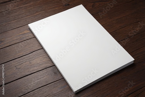 a close up of a white book on a wooden table