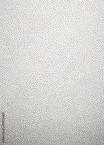 a close-up view white surface with a pattern of small black dots, creating a textured and speckled appearance