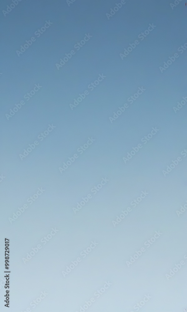 a gradient of blue sky, transitioning from a darker shade at the top to a lighter one at the bottom a gradient of blue sky, transitioning from a darker shade at the top to a lighter one at the bottom