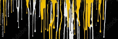 a vertical arrangement of dripping paint in white and yellow against a black background