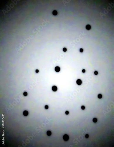 a collection of black dots scattered across a white background, creating a sense of randomness and chaos photo