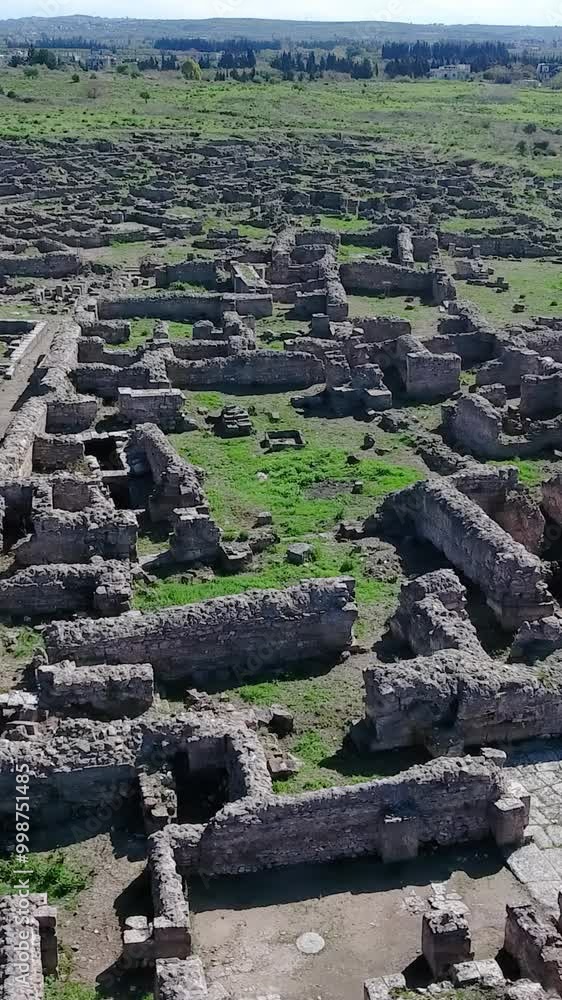 Aerial view of Ugarit's ruins an ancient city-state in Syria on a sunny day, vertical video. Aerial view of Ugarit's ruins an ancient city-state in Syria on a sunny day, vertical video.