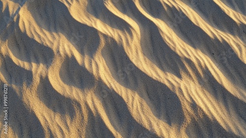 Fototapeta Naklejka Na Ścianę i Meble -  Rippling sand dunes forming mesmerizing patterns under the soft glow of the setting sun