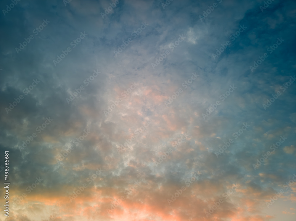 The rays of the sun breaking through the dramatic clouds in the evening or in the morning in the sunset or sunrise sky. The rays of the sun breaking through the dramatic clouds in the evening or in the morning in the sunset or sunrise sky.