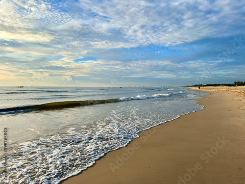 The beach at sunrice is beautiful with gentle waves photo