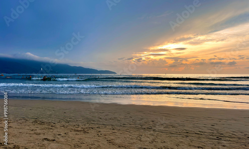 Sunrise on My Khe beach, Da Nang - In front is Son Tra peninsula photo