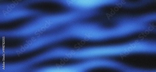 Blurred background of black blue waves with grainy texture photo