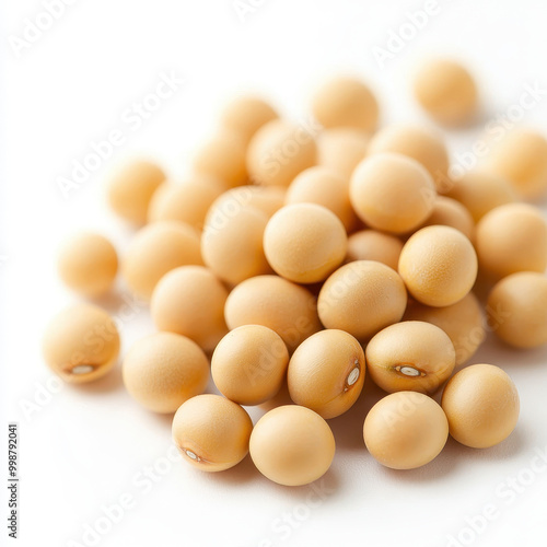 A close-up view of raw soybeans showcasing their smooth texture and natural beige color against a white background.