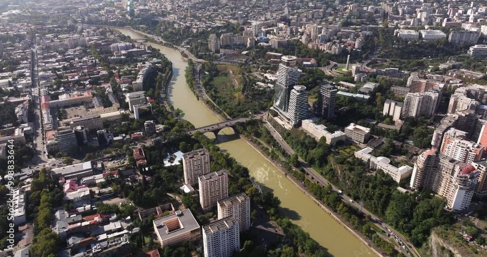 High Aerial View Above Kura River in Downtown Tbilisi, Georgia. Modern Skyscraper Buildings High Aerial View Above Kura River in Downtown Tbilisi, Georgia. Modern Skyscraper Buildings