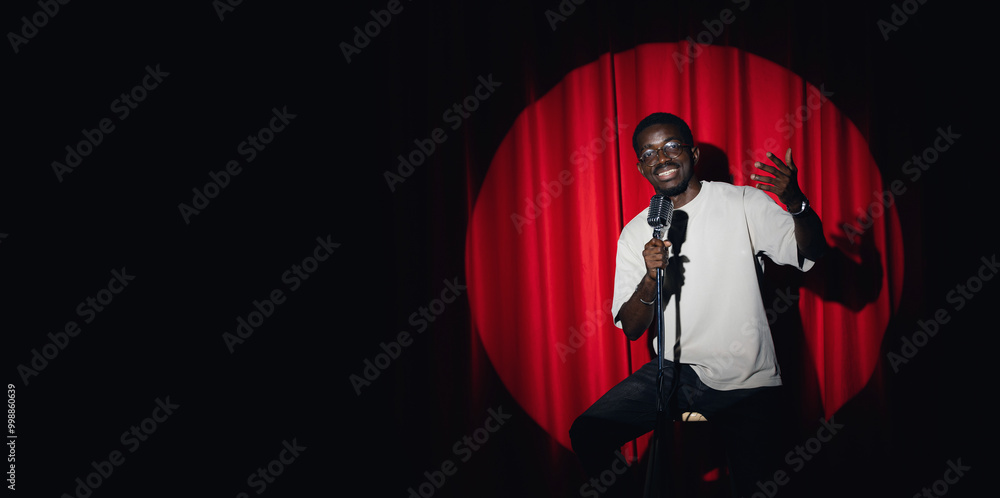 African american man comic with old microphone on theater stage on red curtains background. Concept banner standup comedian show African american man comic with old microphone on theater stage on red curtains background. Concept banner standup comedian show