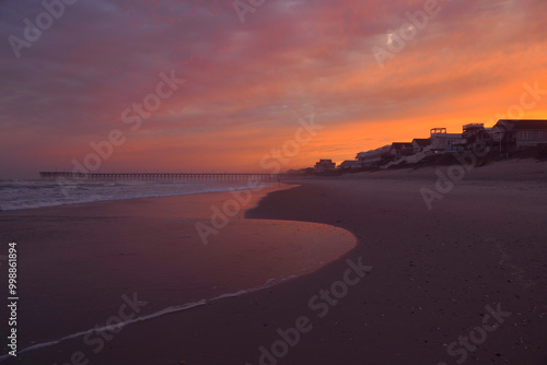 Sunset over the beachfront houses along the beach