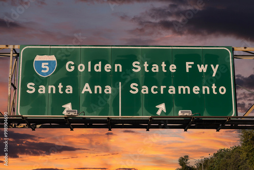 View of Interstate 5 Golden State Freeway sign to Santa Ana or Sacramento in Los Angeles with sunset sky. photo