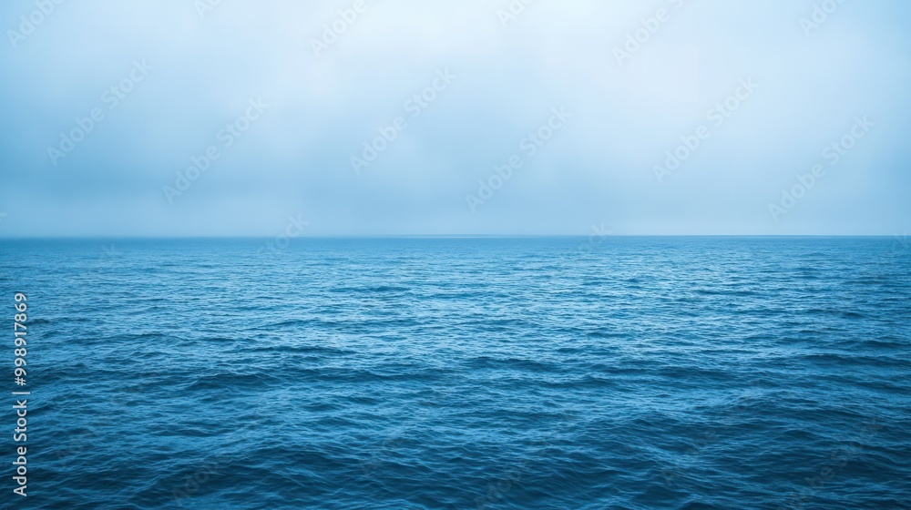 Obraz premium A Calm Blue Ocean Under A Cloudy Sky