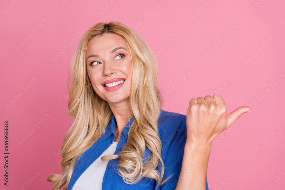 Photo of dreamy pretty lady dressed blue jacket looking showing thumb back empty space isolated pink color background Photo of dreamy pretty lady dressed blue jacket looking showing thumb back empty space isolated pink color background