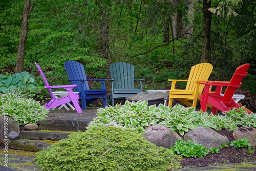 Fototapeta Naklejka Na Ścianę i Meble -  Group of colorful chairs in a garden