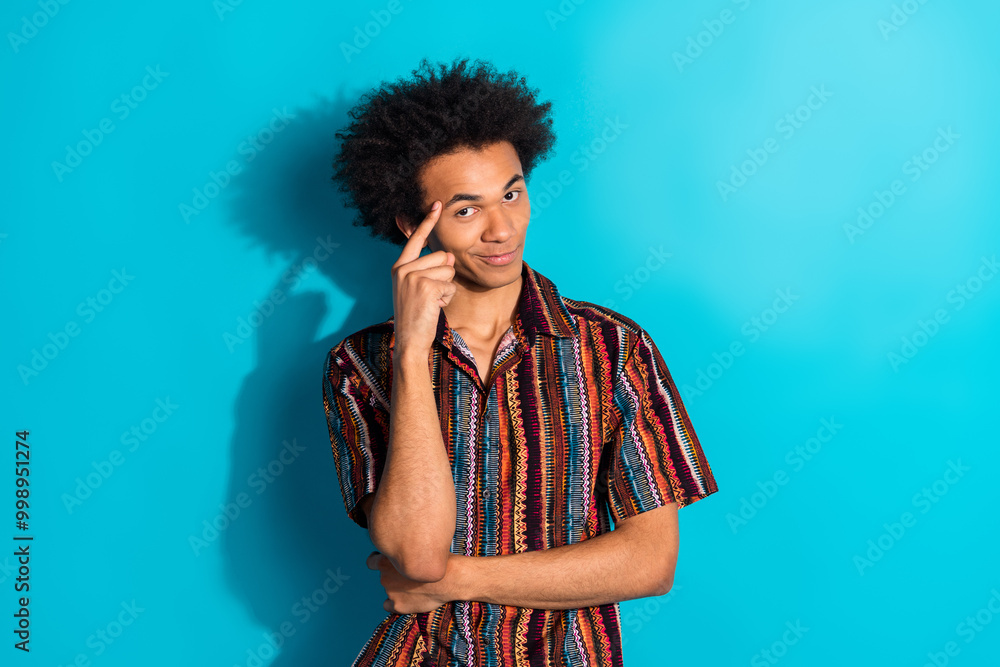 Photo of nice young man finger touch temple think wear shirt isolated on teal color background Photo of nice young man finger touch temple think wear shirt isolated on teal color background
