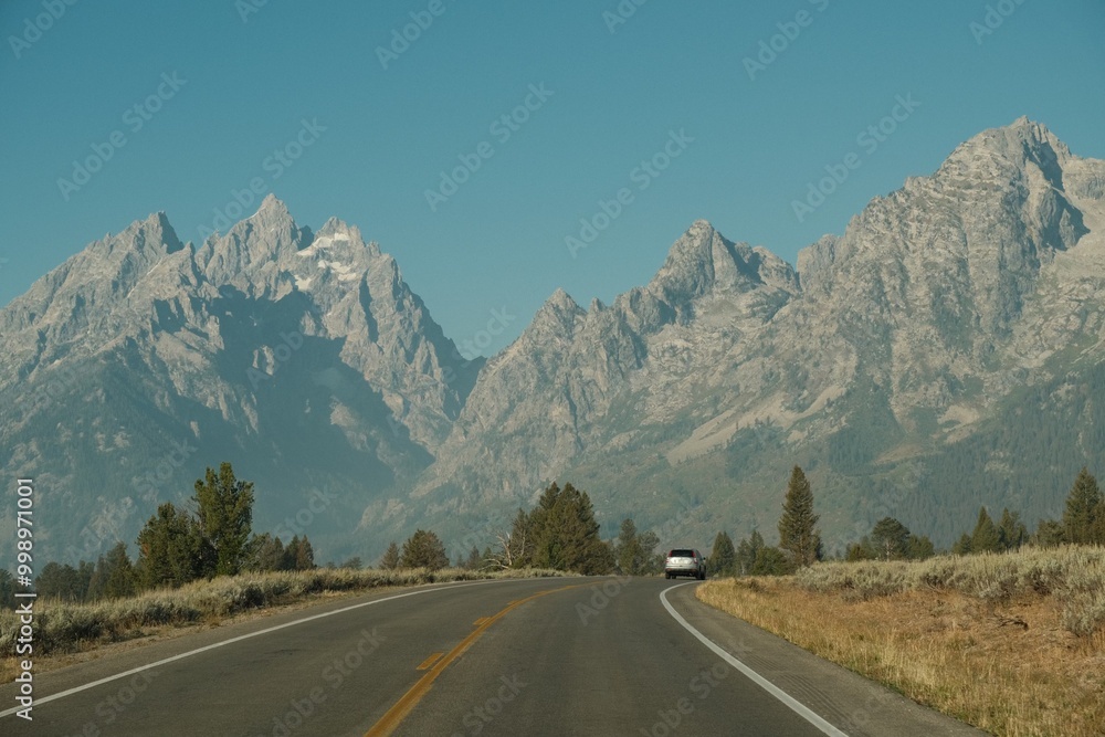 Car driving on highway through the Grand Teton Mountains in Grand Teton National Park Car driving on highway through the Grand Teton Mountains in Grand Teton National Park