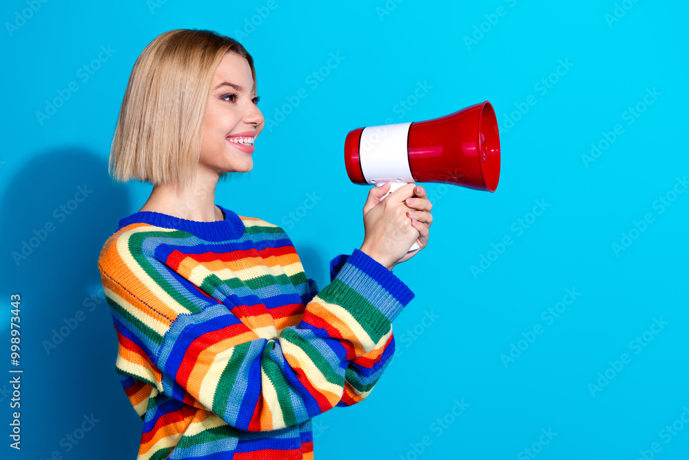 Profile photo of nice young woman loudspeaker wear striped sweater isolated on blue color background