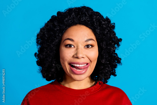 Photo portrait of attractive young woman tongue out lick teeth dressed stylish red clothes isolated on blue color background