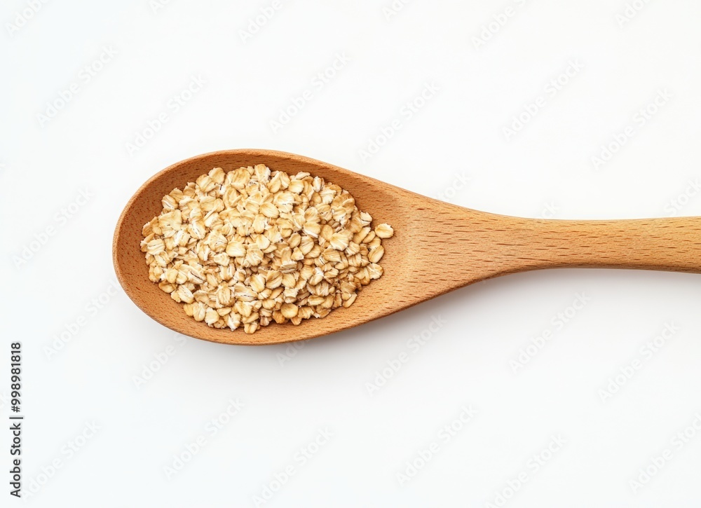 Wooden spoon with a dry breakfast of rolled oats on a white background. National oatmeal day Wooden spoon with a dry breakfast of rolled oats on a white background. National oatmeal day