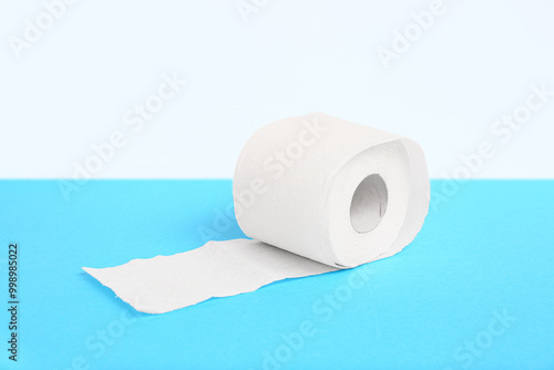 Roll of toilet paper on blue background