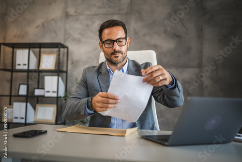 businessman organize documents to be sent by envelope in office