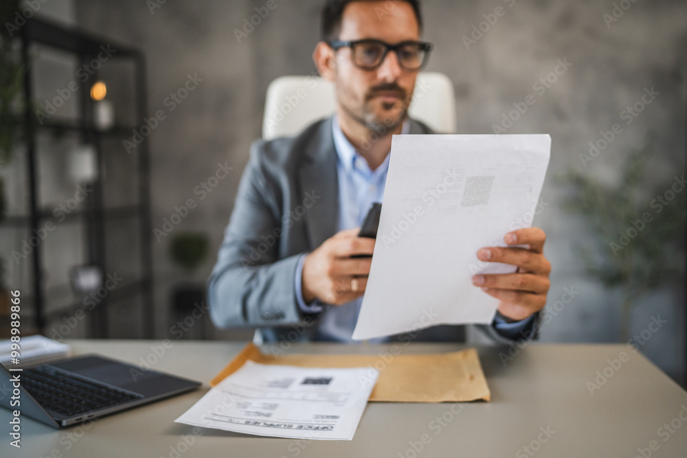 Businessman sit in office and have contactless payment on cellphone Businessman sit in office and have contactless payment on cellphone