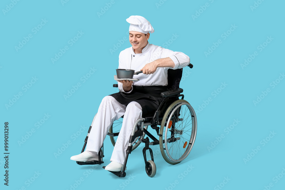 Male chef in wheelchair with cooking pot on blue background Male chef in wheelchair with cooking pot on blue background