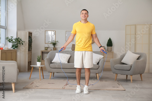 Sporty young man jumping wi...