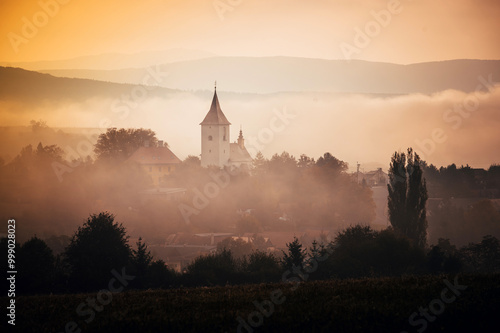 Tranquil Autumn Morning, A Rural Church Silhouette in the Mist