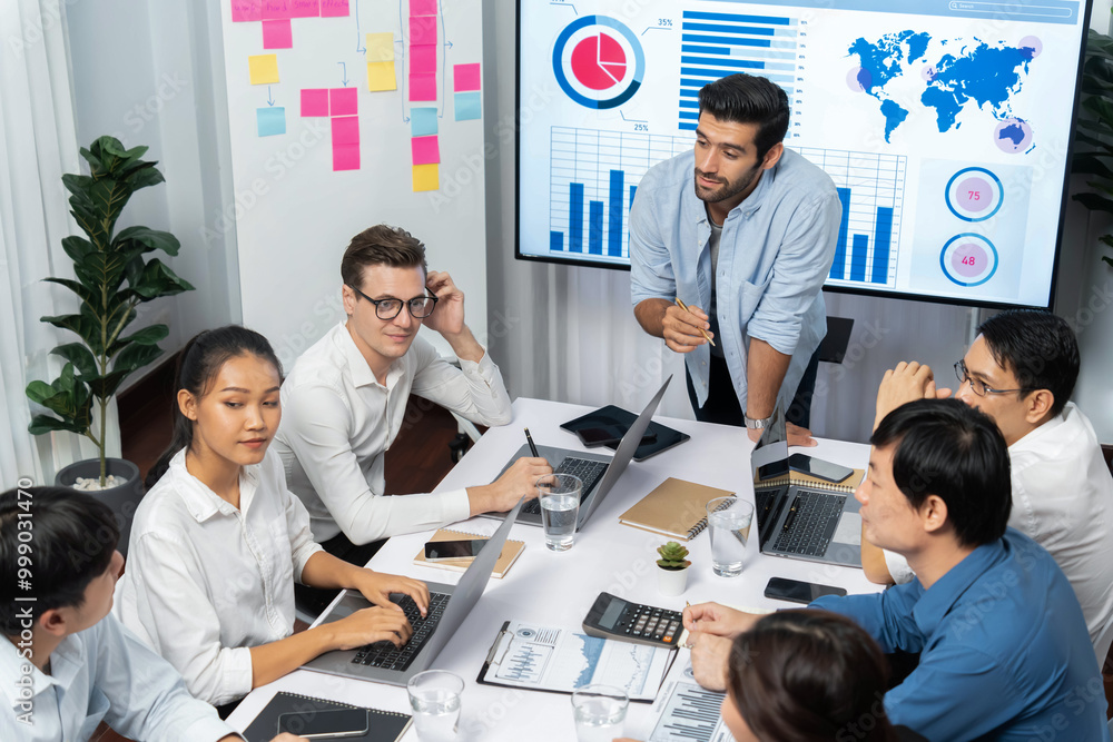 Analyst team utilizing BI Fintech to analyze financial data at table in meeting room. Businesspeople analyzing BI dashboard power for business insight and strategic marketing planning. Prudent Analyst team utilizing BI Fintech to analyze financial data at table in meeting room. Businesspeople analyzing BI dashboard power for business insight and strategic marketing planning. Prudent