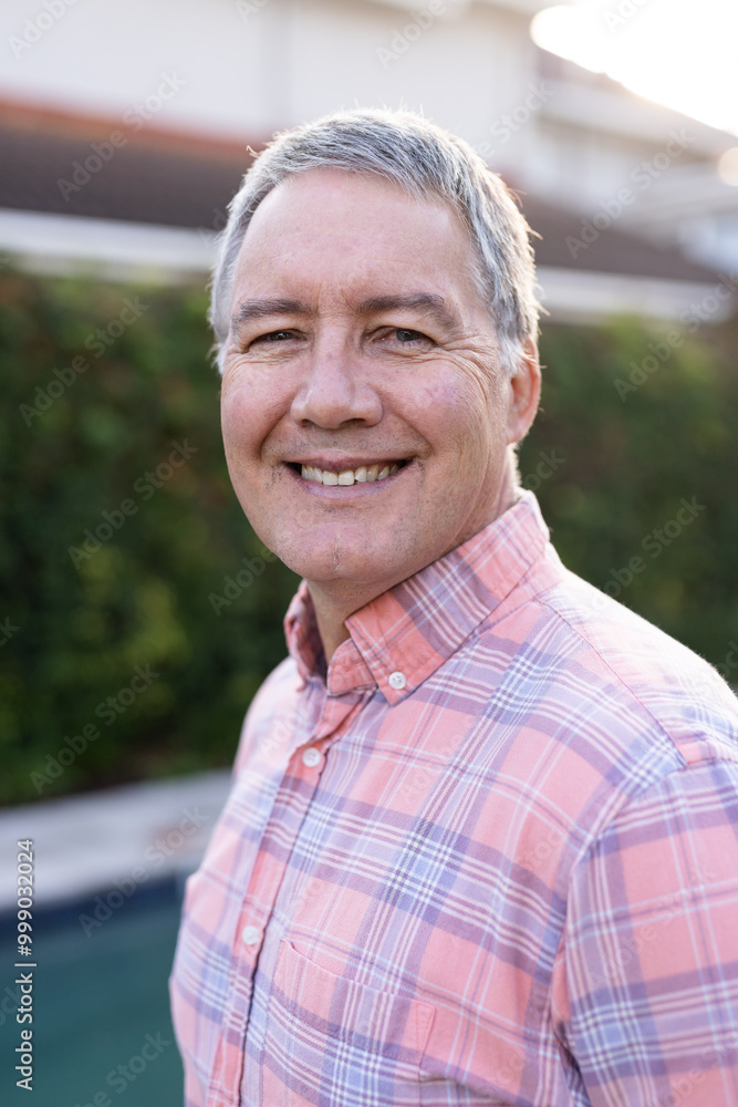 Smiling senior man in plaid shirt enjoying outdoor time with diverse friends, at home Smiling senior man in plaid shirt enjoying outdoor time with diverse friends, at home