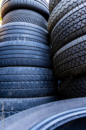 Obraz na płótnie Stack of old, worn and damaged tires lying in a landfill. Decreased road safety and environmental pollution from rubber waste w salonie
