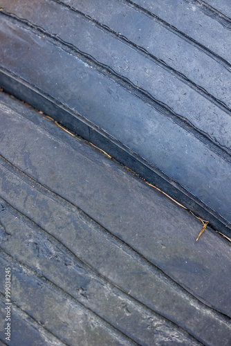 Obraz na płótnie Worn and damaged tread of old tires lying in a landfill. Decreased road safety and environmental pollution from rubber waste w salonie