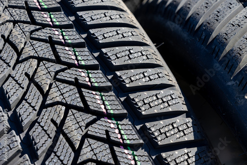 Obraz na płótnie Sharp tread of new winter tires ready for the seasonal change. New tires are important for increasing road safety w salonie
