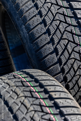 Obraz na płótnie Sharp tread of new winter tires ready for the seasonal change. New tires are important for increasing road safety w salonie