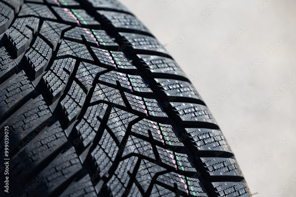 Sharp tread of new winter tires ready for the seasonal change. New tires are important for increasing road safety