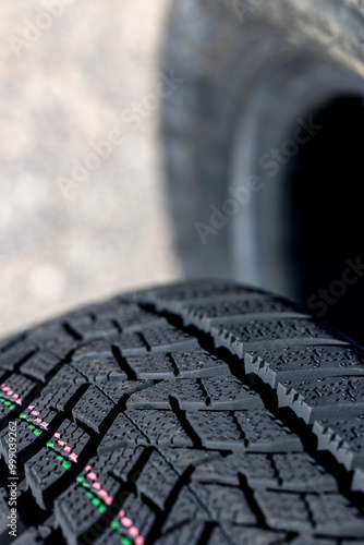 Obraz na płótnie Sharp tread of new winter tires ready for the seasonal change. New tires are important for increasing road safety w salonie